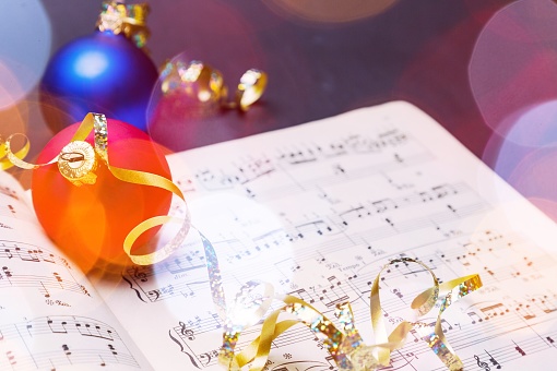 Christmas tree colorful toys with music book close-up in sunlight